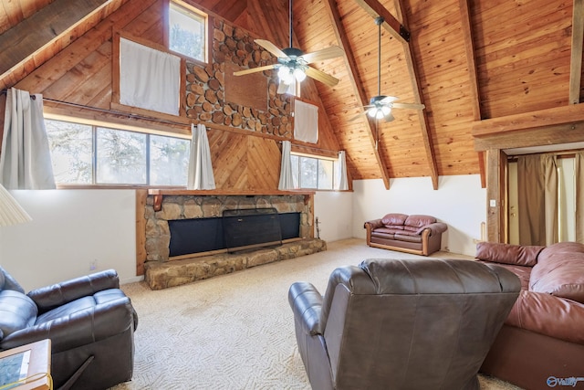 carpeted living room featuring beamed ceiling, wood ceiling, a stone fireplace, high vaulted ceiling, and ceiling fan