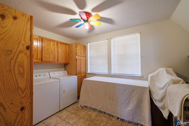 clothes washing area featuring ceiling fan, washer and dryer, cabinets, a textured ceiling, and light tile patterned floors