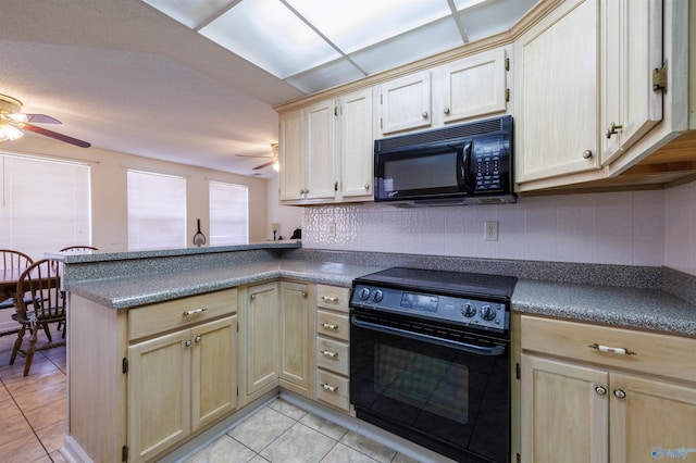 kitchen featuring light tile patterned flooring, tasteful backsplash, kitchen peninsula, ceiling fan, and black appliances