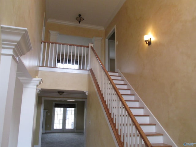 stairs featuring ornamental molding, french doors, carpet flooring, and ornate columns