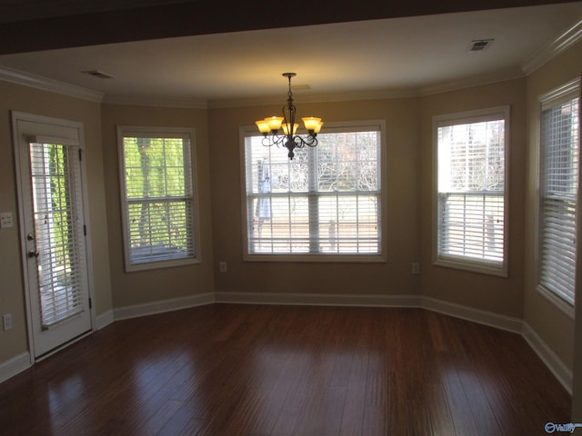 unfurnished dining area with a notable chandelier, ornamental molding, and dark hardwood / wood-style floors