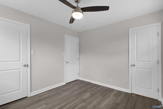 unfurnished bedroom with ceiling fan and dark hardwood / wood-style floors