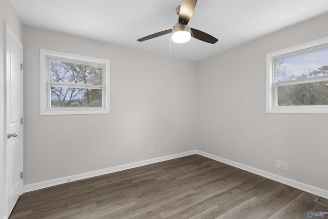 empty room with ceiling fan and dark hardwood / wood-style floors