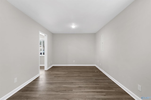 empty room with dark wood-type flooring