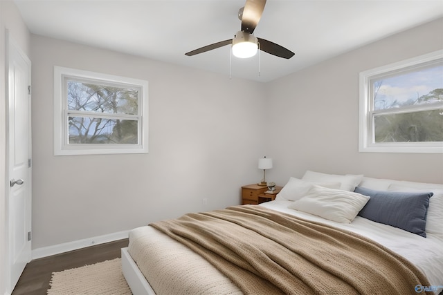 bedroom with ceiling fan and dark hardwood / wood-style floors