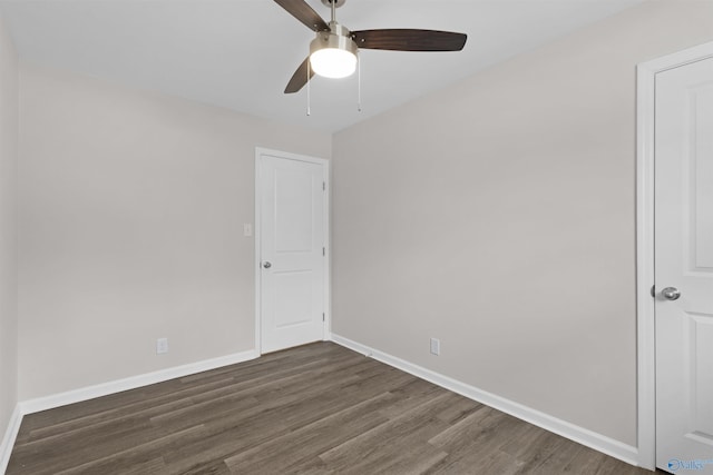 spare room with ceiling fan and dark wood-type flooring