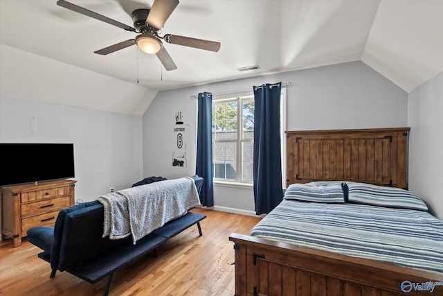 bedroom with lofted ceiling, visible vents, light wood finished floors, and ceiling fan