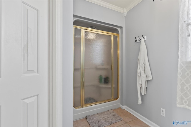 full bathroom with a shower stall, crown molding, baseboards, and tile patterned floors