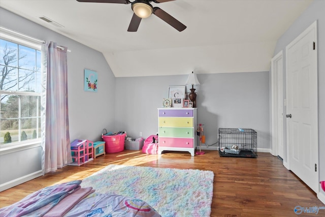 playroom featuring wood finished floors, visible vents, baseboards, ceiling fan, and vaulted ceiling