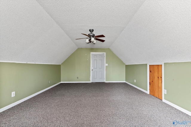 bonus room with ceiling fan, baseboards, lofted ceiling, and carpet