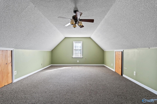 additional living space with a ceiling fan, carpet, baseboards, vaulted ceiling, and a textured ceiling