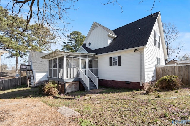 rear view of property with crawl space, fence, stairs, and a sunroom