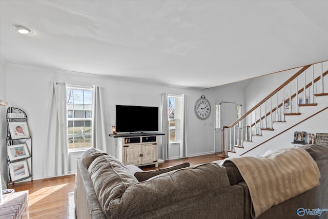 living room featuring stairway, wood finished floors, and baseboards