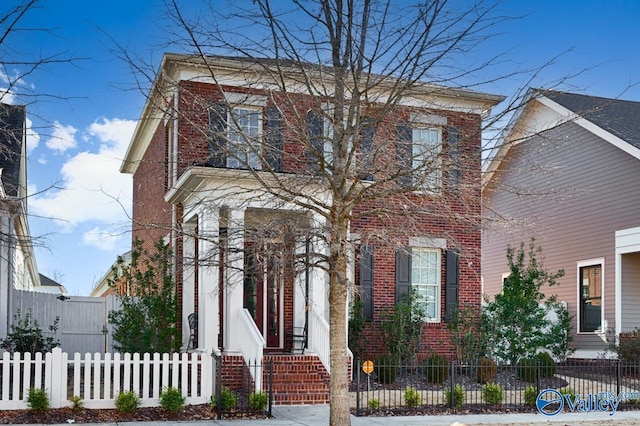 view of front of house with brick siding and a fenced front yard