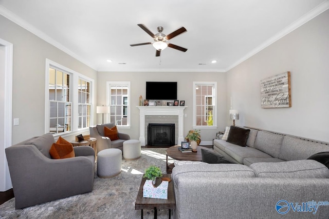 living area with a fireplace with flush hearth, recessed lighting, crown molding, and a ceiling fan