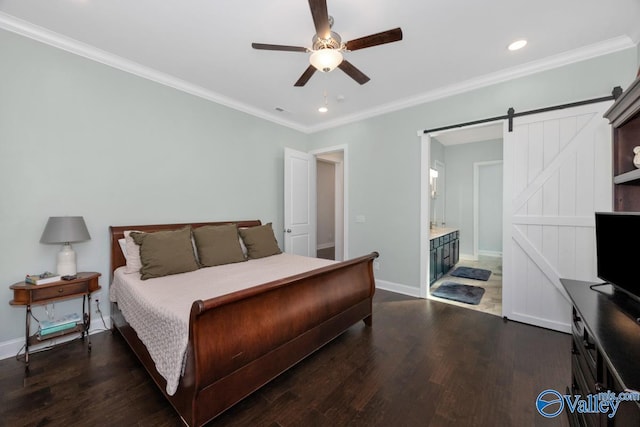 bedroom with crown molding, a barn door, dark wood-type flooring, and baseboards