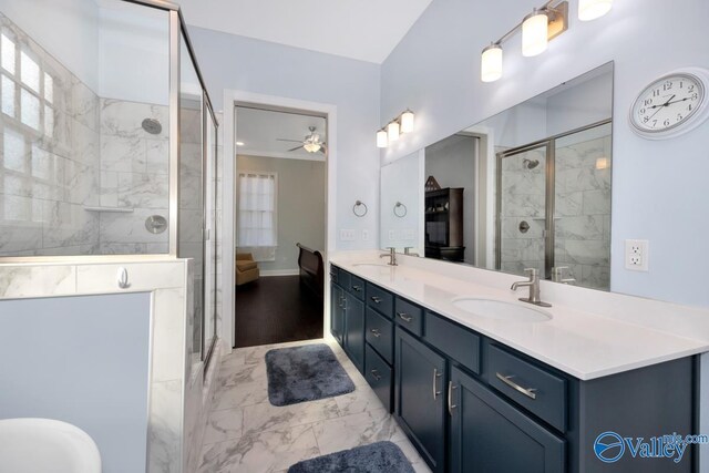 ensuite bathroom featuring marble finish floor, double vanity, a stall shower, and a sink