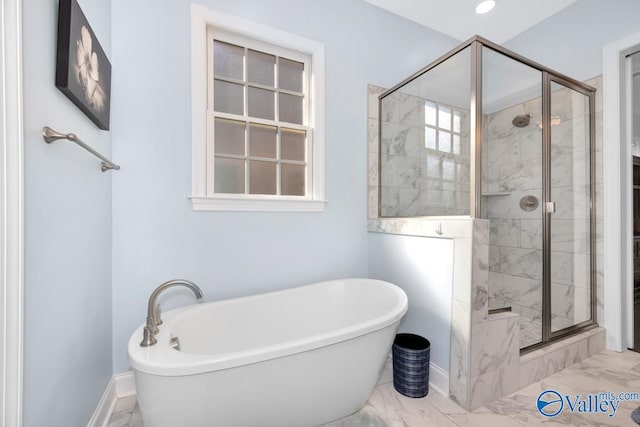 full bath with marble finish floor, baseboards, a stall shower, and a soaking tub