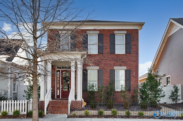 view of front of house featuring a fenced front yard and brick siding