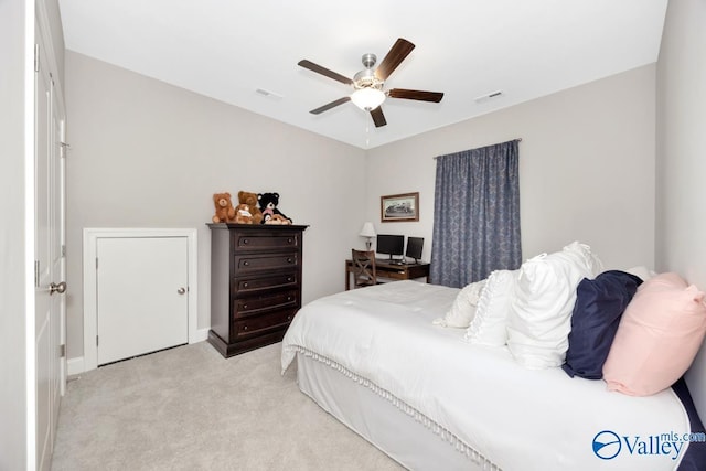 bedroom with light carpet, visible vents, and a ceiling fan