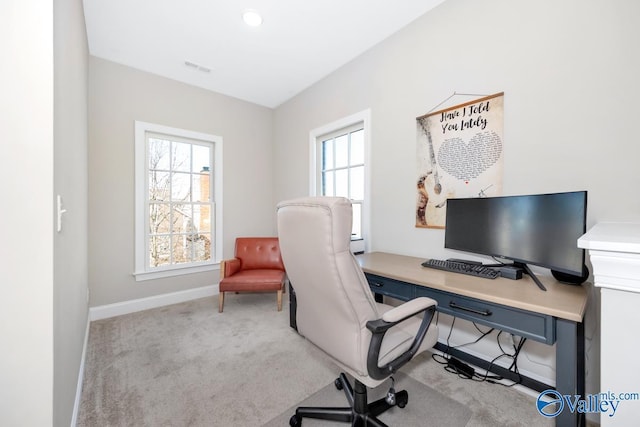 home office featuring light carpet, visible vents, and baseboards