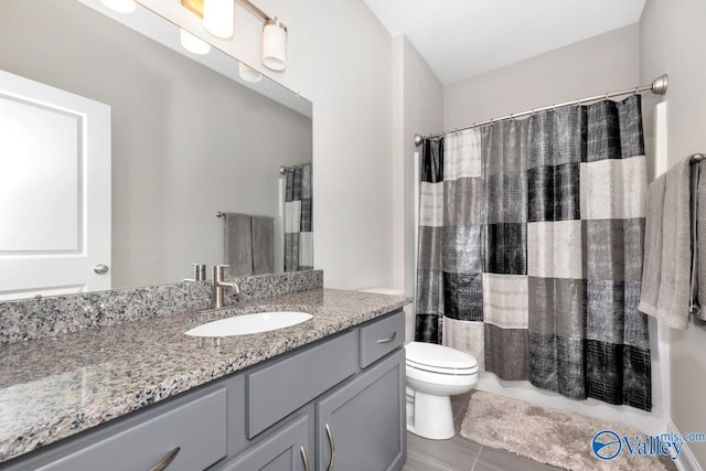 bathroom featuring toilet, vanity, and a shower with curtain