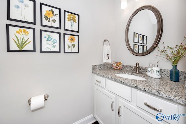 bathroom with baseboards and vanity