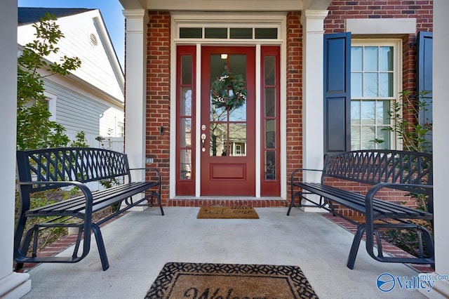 entrance to property featuring brick siding