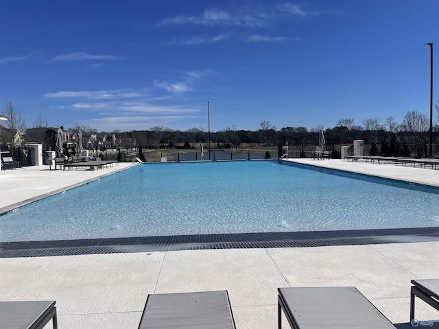 pool featuring fence and a patio