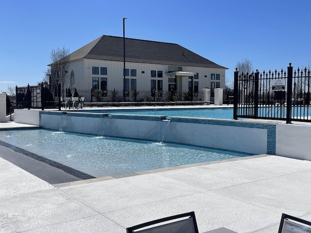 community pool featuring a patio and fence