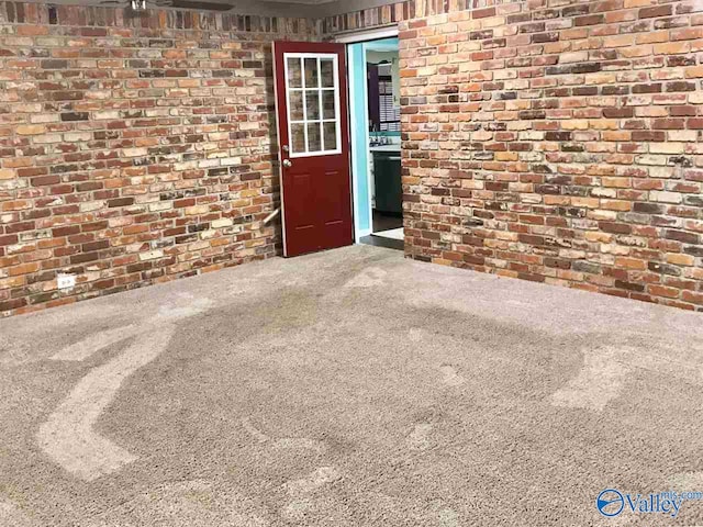 view of exterior entry with brick siding