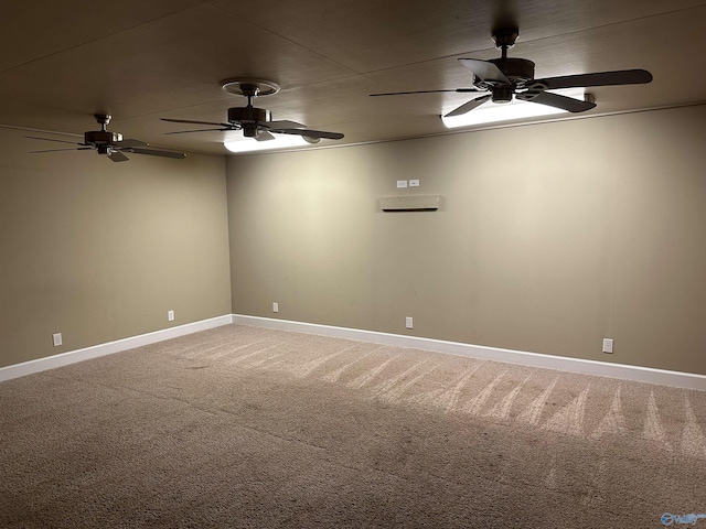 spare room with light carpet, a ceiling fan, and baseboards