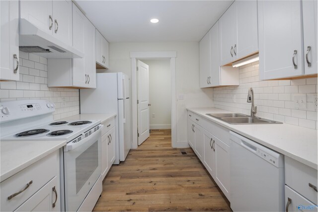 kitchen with white cabinetry, sink, and white appliances