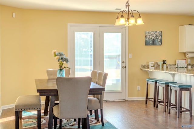 dining area featuring dark hardwood / wood-style floors and a notable chandelier