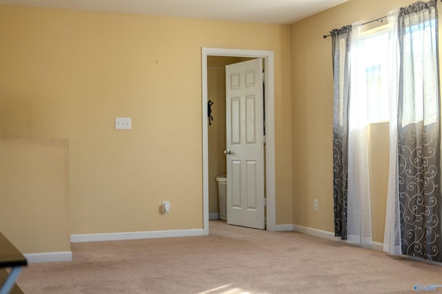 empty room featuring light carpet