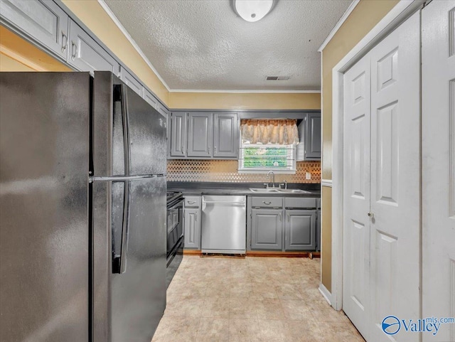 201 10th Ave NW, Decatur, AL 35601 - kitchen featuring freestanding refrigerator, dishwasher, gray cabinetry, a sink, and dark countertops
