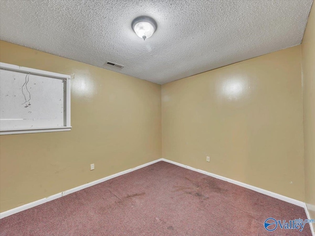 201 10th Ave NW, Decatur, AL 35601 - empty room featuring carpet floors, a textured ceiling, and baseboards