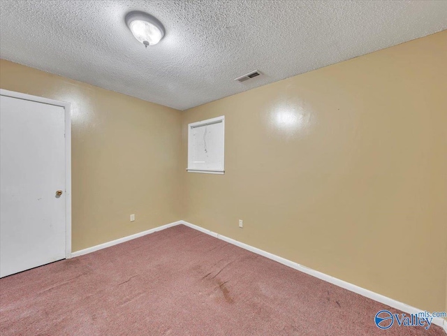 201 10th Ave NW, Decatur, AL 35601 - empty room featuring carpet floors, a textured ceiling, and baseboards
