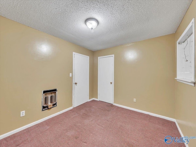 201 10th Ave NW, Decatur, AL 35601 - empty room featuring heating unit, carpet flooring, a textured ceiling, and baseboards