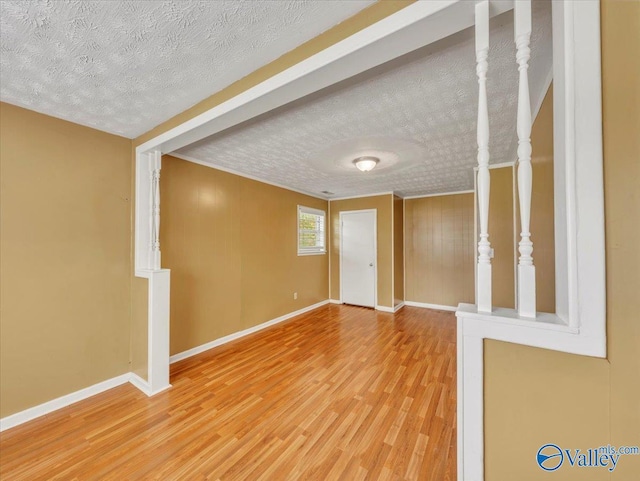 201 10th Ave NW, Decatur, AL 35601 - unfurnished room featuring light wood-style floors, baseboards, and a textured ceiling