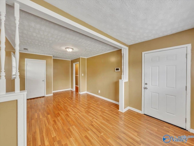 201 10th Ave NW, Decatur, AL 35601 - foyer with a textured ceiling, light wood-style floors, and baseboards
