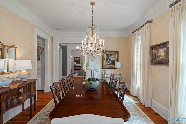 19 Ledges Main SE, Huntsville, AL 35802 - dining room with wood finished floors, plenty of natural light, a chandelier, wallpapered walls, and ornamental molding