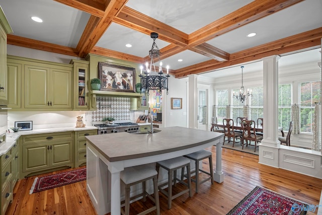 19 Ledges Main SE, Huntsville, AL 35802 - kitchen with green cabinets, a chandelier, ornate columns, light wood finished floors, and a sink