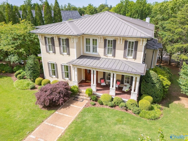 19 Ledges Main SE, Huntsville, AL 35802 - view of front of home featuring a standing seam roof, metal roof, covered porch, a front yard, and a chimney