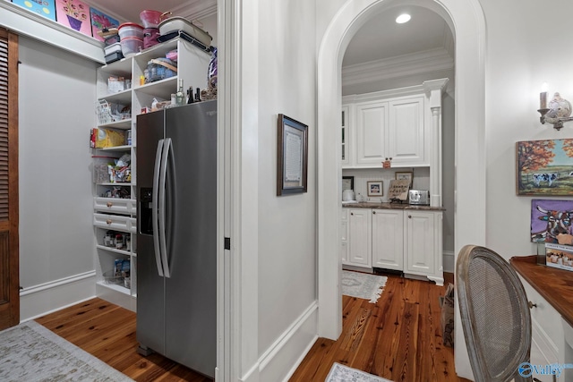 19 Ledges Main SE, Huntsville, AL 35802 - kitchen featuring stainless steel refrigerator with ice dispenser, arched walkways, crown molding, dark wood-type flooring, and white cabinets