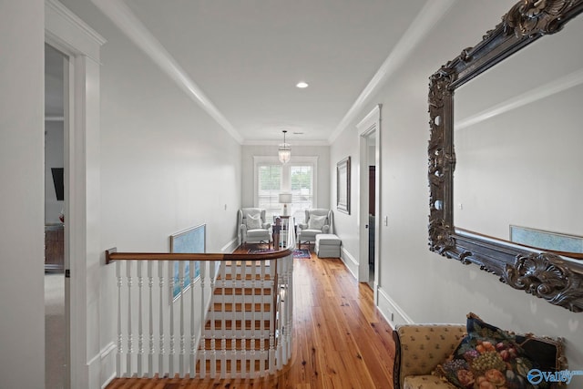 19 Ledges Main SE, Huntsville, AL 35802 - hallway featuring light wood-type flooring, baseboards, crown molding, recessed lighting, and an upstairs landing