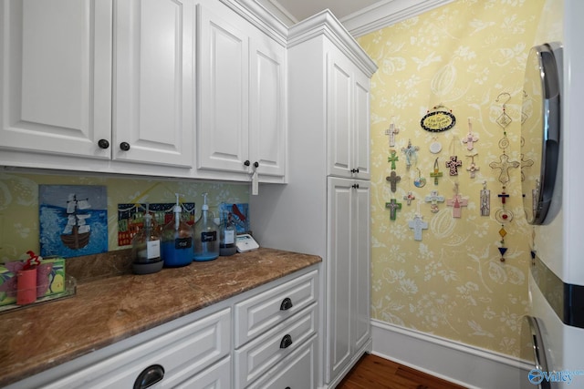19 Ledges Main SE, Huntsville, AL 35802 - kitchen with white cabinets, wallpapered walls, dark wood-type flooring, dark stone counters, and crown molding