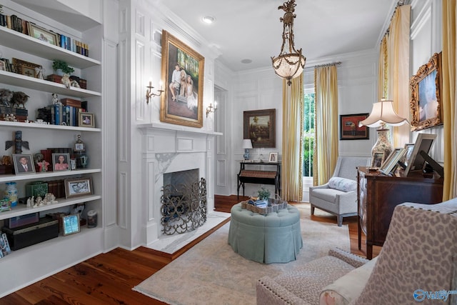 19 Ledges Main SE, Huntsville, AL 35802 - living room featuring ornamental molding, wood finished floors, a fireplace, and built in shelves