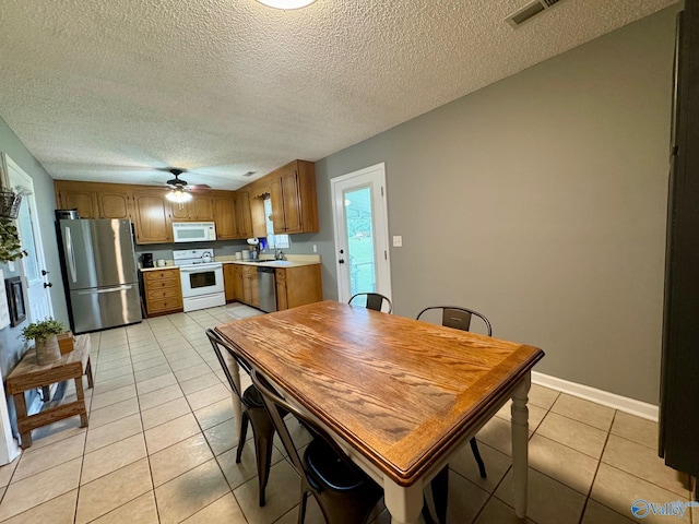 28035 Holland Gin Rd, Elkmont, AL 35620 - dining area featuring light tile patterned floors, a textured ceiling, and ceiling fan