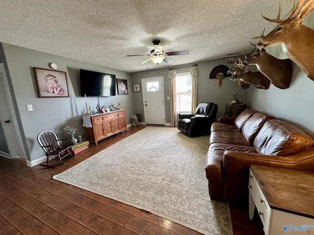 28035 Holland Gin Rd, Elkmont, AL 35620 - living area featuring ceiling fan, dark wood finished floors, and a textured ceiling